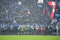 Como players celebrate their 2-1 win over Napoli in February 2025 in front of a raucous crowd of celebrating fans