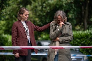 Gemma Whelan comforts a crying Claire Mills behind police tape.