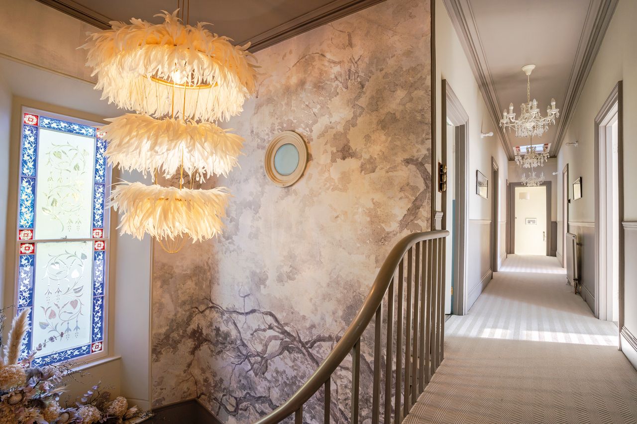 Staircase with elegant woodland wallpaper