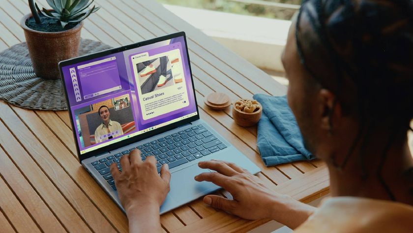 Man using Dell Inspiron 14 Plus on wooden tablet