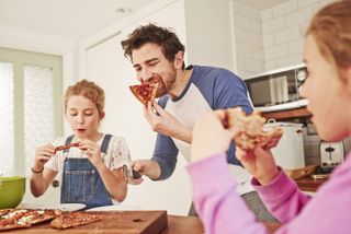 family eating takeaway pizza in lockdown