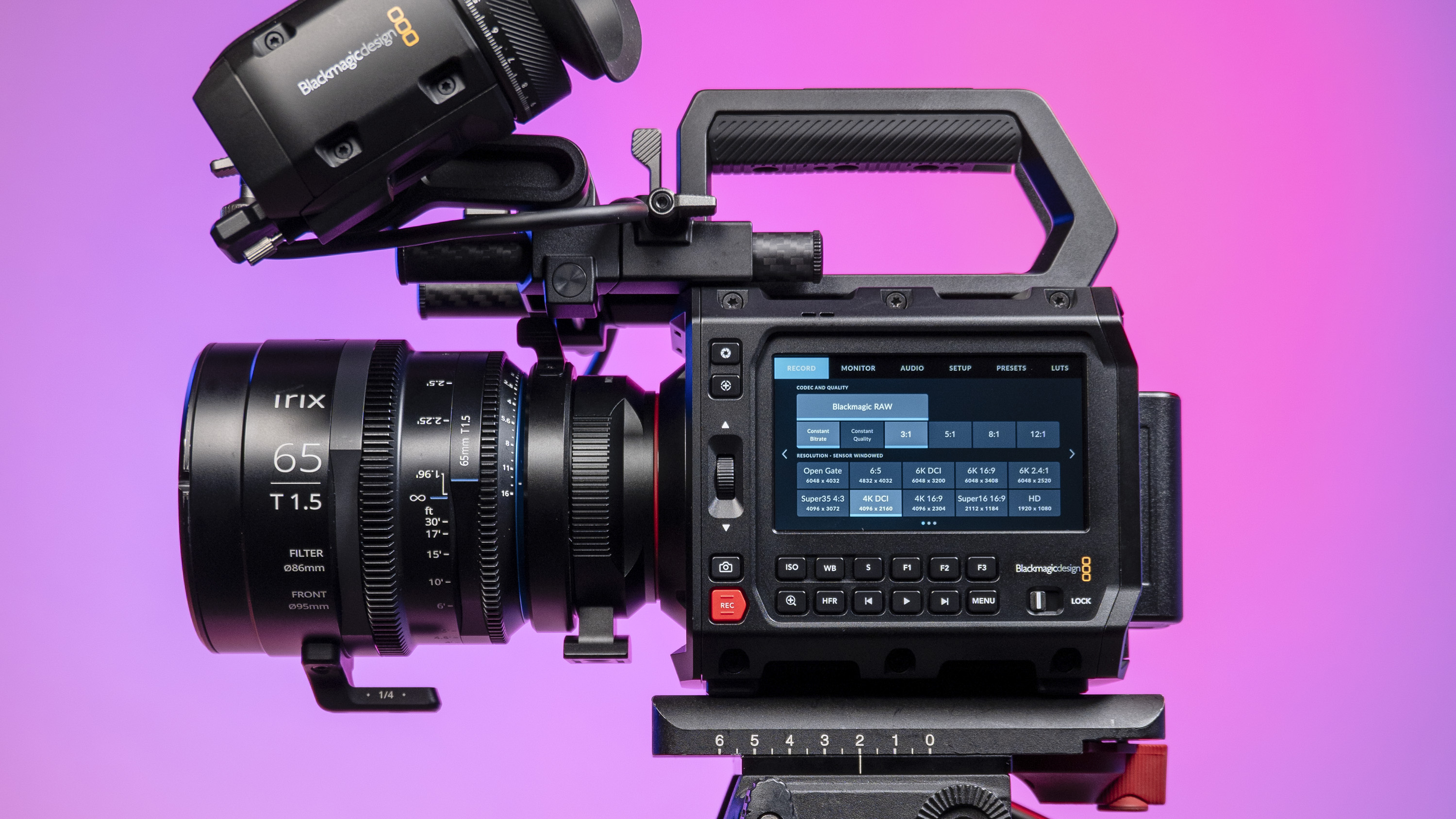 Blackmagic Pyxis 6K camera in the studio, mounted to video tripod, with a vibrant magenta background