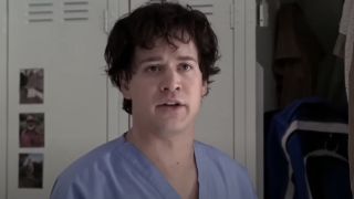 George O'Malley (T.R. Knight) has a conversation with co-stars on Grey's Anatomy