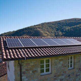 Row of solar panels on roof of house