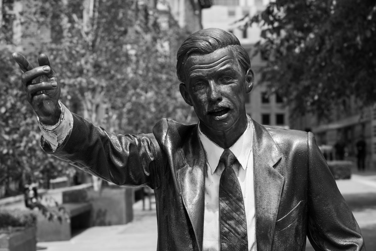 The statue of a man hailing a cab