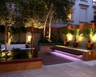 paved courtyard garden with decking inset and lighting
