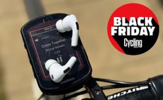 A pair of Apple AirPods Pro 2 sitting on a Garmin 840 and showing the music screen with the Cycling Weekly Black Friday 2025 logo
