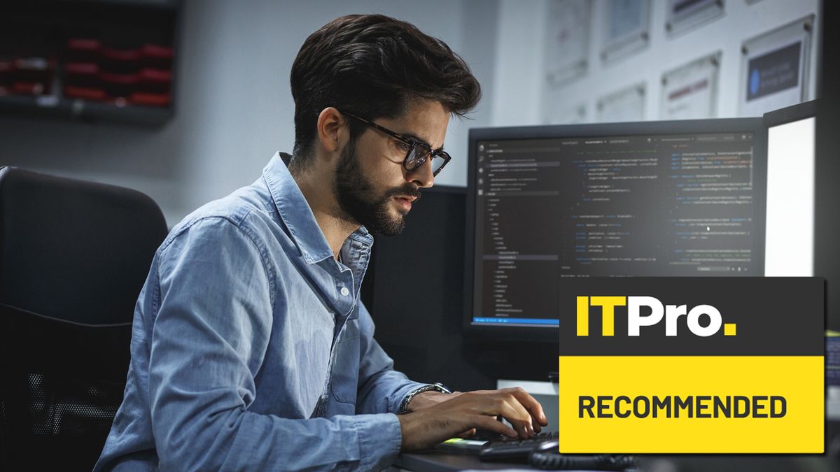 man working on computers at desk