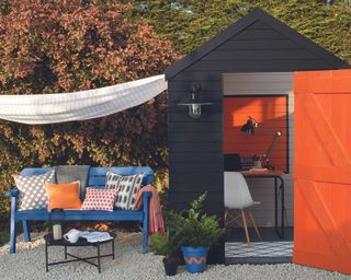 Black and orange shed used as outdoor home office space by Cuprinol