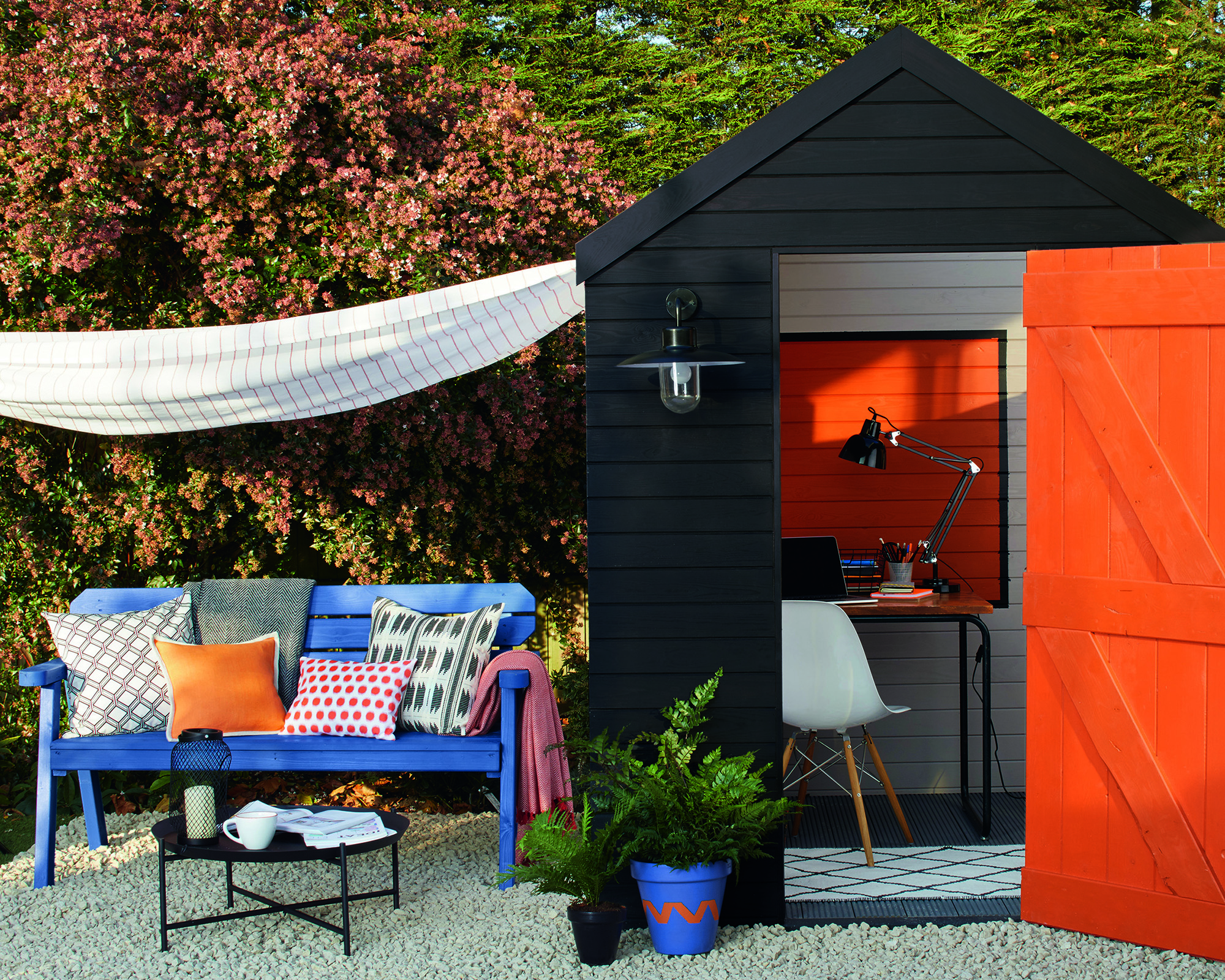 Black and orange shed used as outdoor home office space by Cuprinol