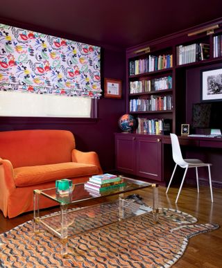 A purple office with an orange sofa
