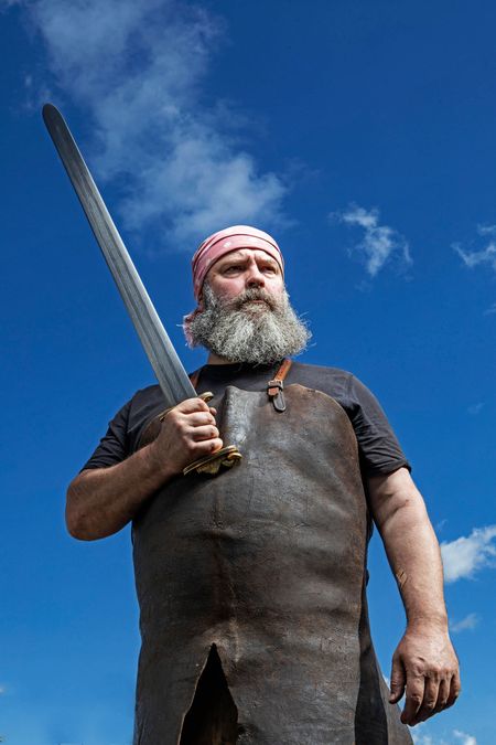 Soul into steel: the formidable Owen Bush wields one of his magnificent swords. Photographed at his workshop by Richard Cannon for Country Life.