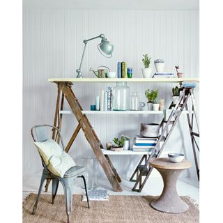 grey wall with ladder and chair with cushion