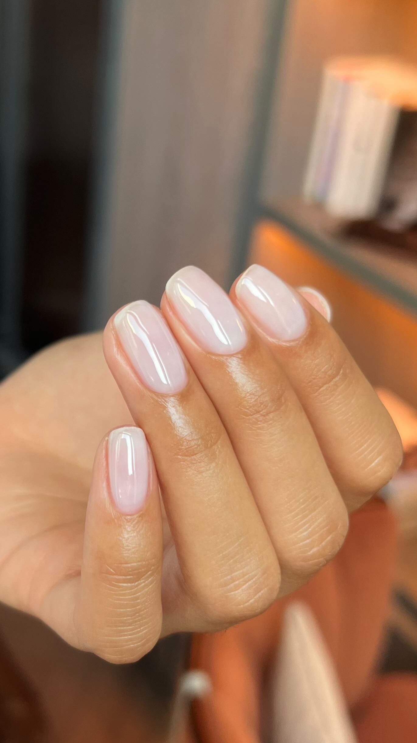 A set of nails by @raelondonnails with squoval-shaped nails finished with a glossy sheer white polish