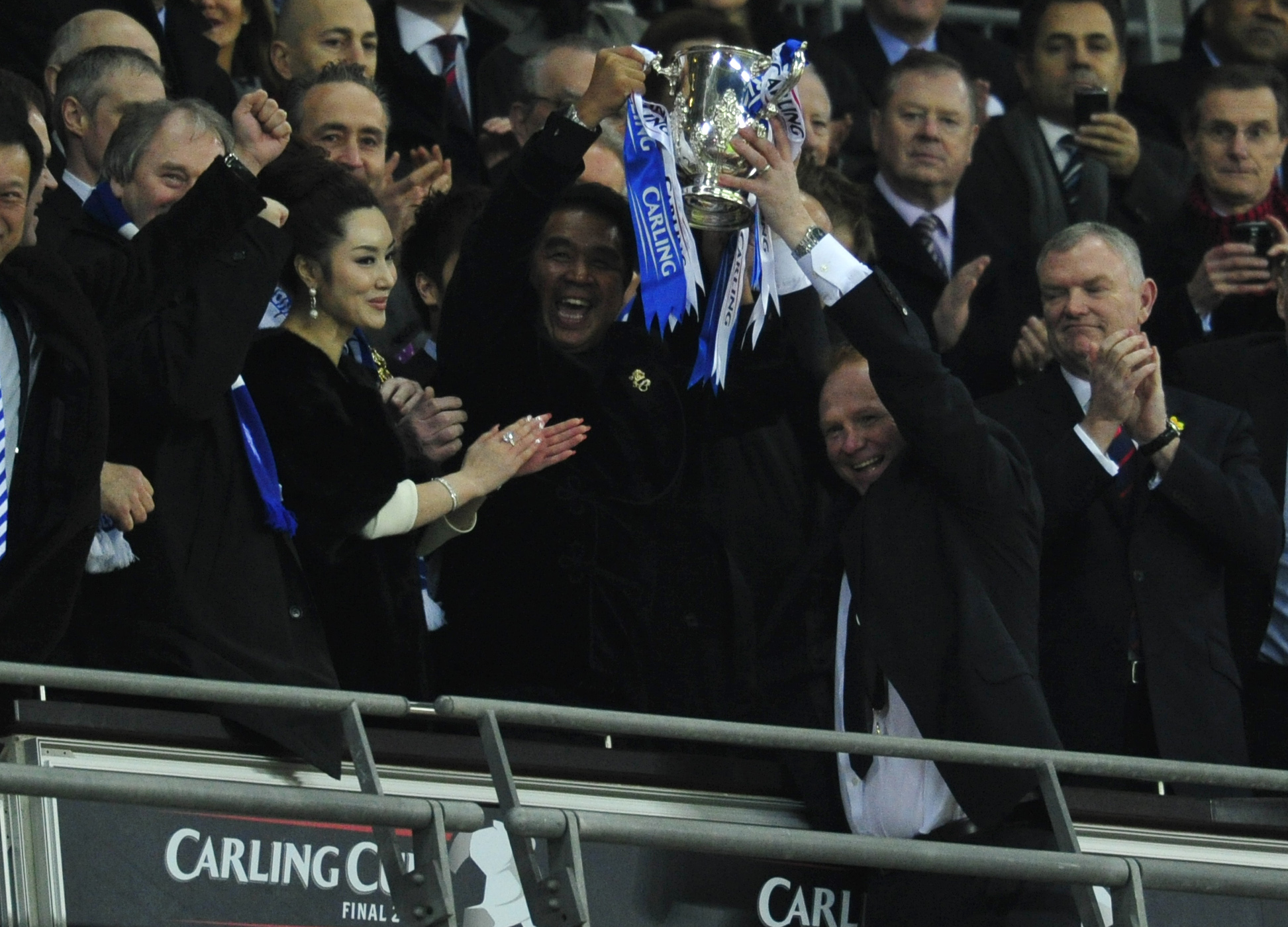 Birmingham City&amp;amp;apos;s coach Alex McLeish (R) and Hong Kong owner of the club, Carson Yeung hold the trophy at the end of the Carling Cup final football match between Arsenal and Birmingham at the Wembley Stadium in London on February 27, 2011. Birmingham City won 2-1. AFP PHOTO/GLYN KIRKFOR EDITORIAL USE ONLY Additional licence required for any commercial/promotional use or use on TV or internet (except identical online version of newspaper) of Premier League/Football League photos. Tel DataCo +44 207 2981656. Do not alter/modify photo. (Photo credit should read GLYN KIRK/AFP via Getty Images)