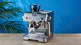 De'Longhi La Specialista Opera is a stainless steel manual espresso machine with smart tamping, a group handle, steam wand, and grinder