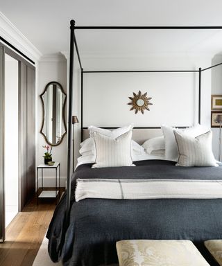four poster bed with white pillows