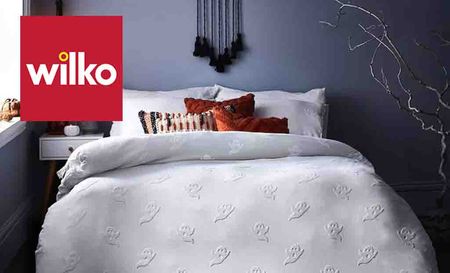 Wilko logo top left with a picture of a bed in halloween decorations