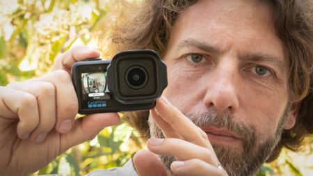 Adam Juniper holding a GoPro Mission 1 Pro camera