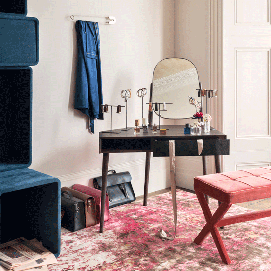 room with dressing table and bags and newspaper