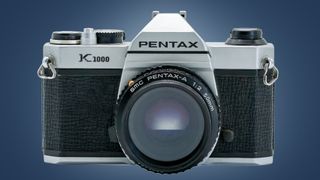 The Pentax K1000 camera on a blue background