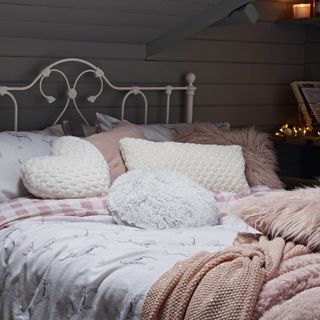 bedroom with wooden wall and bed with pillows