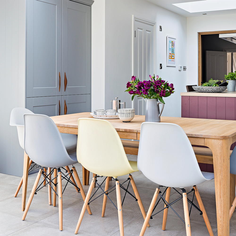 dining room with white wall and flower pot on table