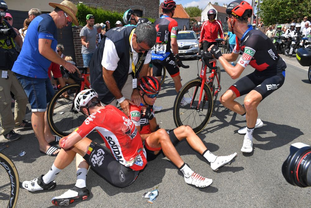 The race doctor checks Porte's shoulder after the crash
