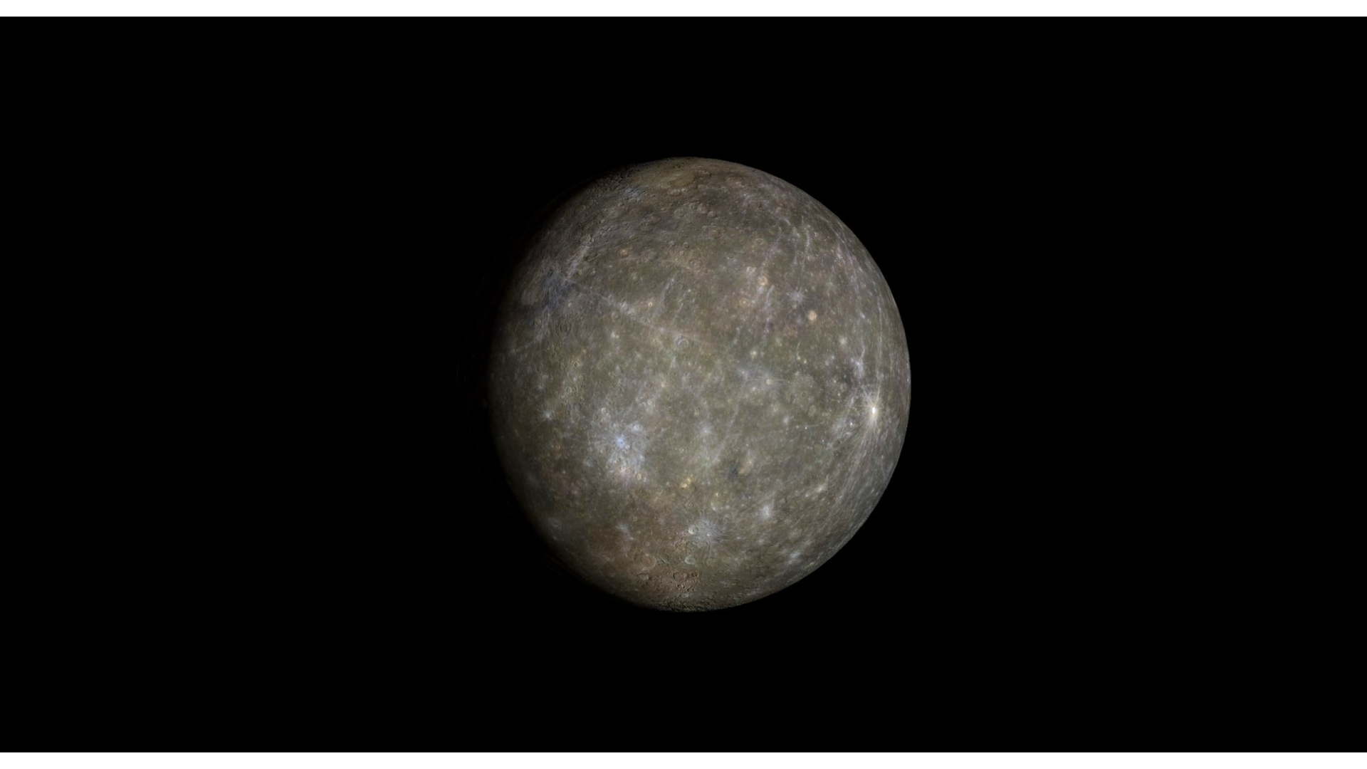 A close up of the planet Mercury in the darkness of space, with its grayish surface dotted with bright colored areas.