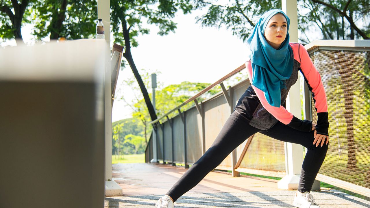 Woman in hijab doing lunges for weight loss