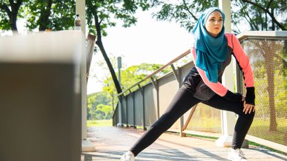 Woman in hijab doing lunges for weight loss