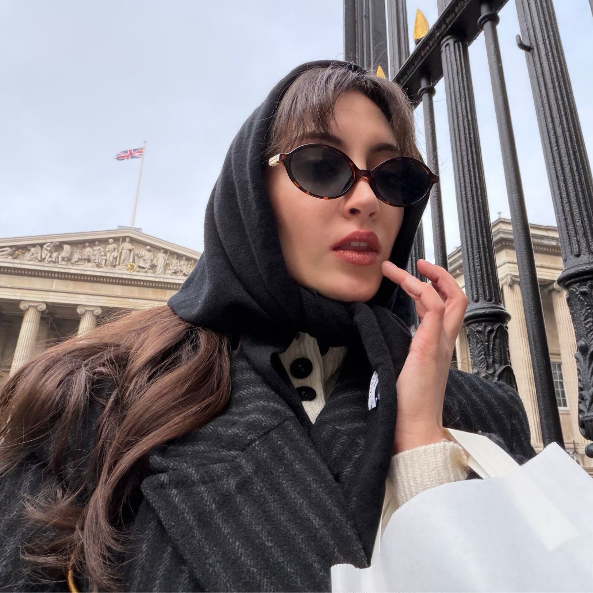 An image of Alyssa Brascia wearing a head scarf and sunglasses in London.