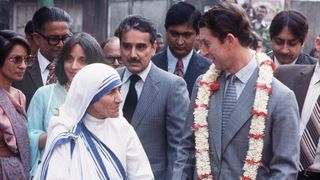 Prince Charles, Prince of Wales, wearing a garland, visits Mother Teresa on December 5, 1980 during his visit to Calcutta, India.