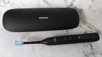 Philips Sonicare 9000 DiamondClean electric toothbrush beside charging case