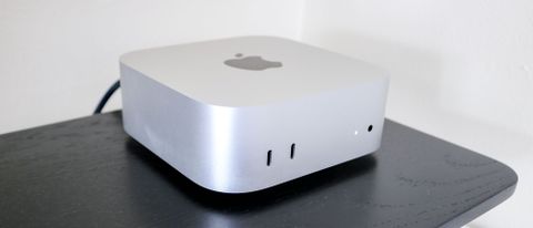 The Mac mini M4 on top of a desk riser shelf