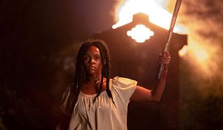 Antebellum Janelle Monae stands with a torch in hand