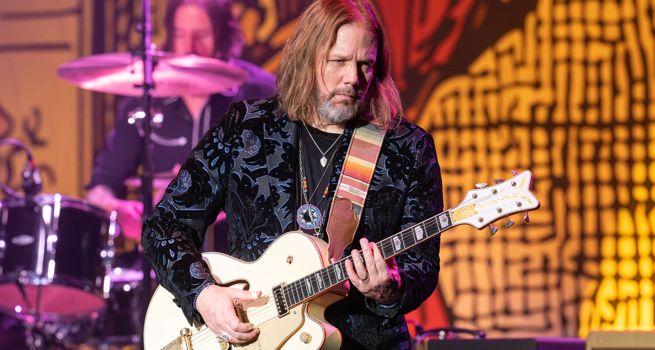 Rich Robinson of the Black Crowes plays a Gretsch White Falcon onstage in 2024