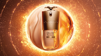 A product picture of the Clarins Double Serum Foundations, surrounded by a circle split into foundation and serum, and fiery, sun-like circles around it/ on a bronze-coloured background