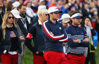 Keegan Bradley of the United States and partner Jillian Stacey (L) look dejected with Bubba Watson of the United States and wife Angie after Europe won the Ryder Cup during the Singles Matches of the 2014 event