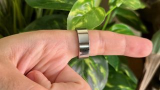 The Ultrahuman Ring Air worn on an index finger.