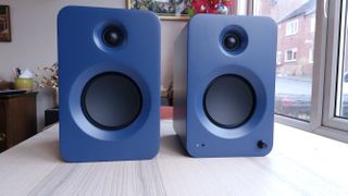 Kanto Ren speakers in blue, within a hi-fi listening room