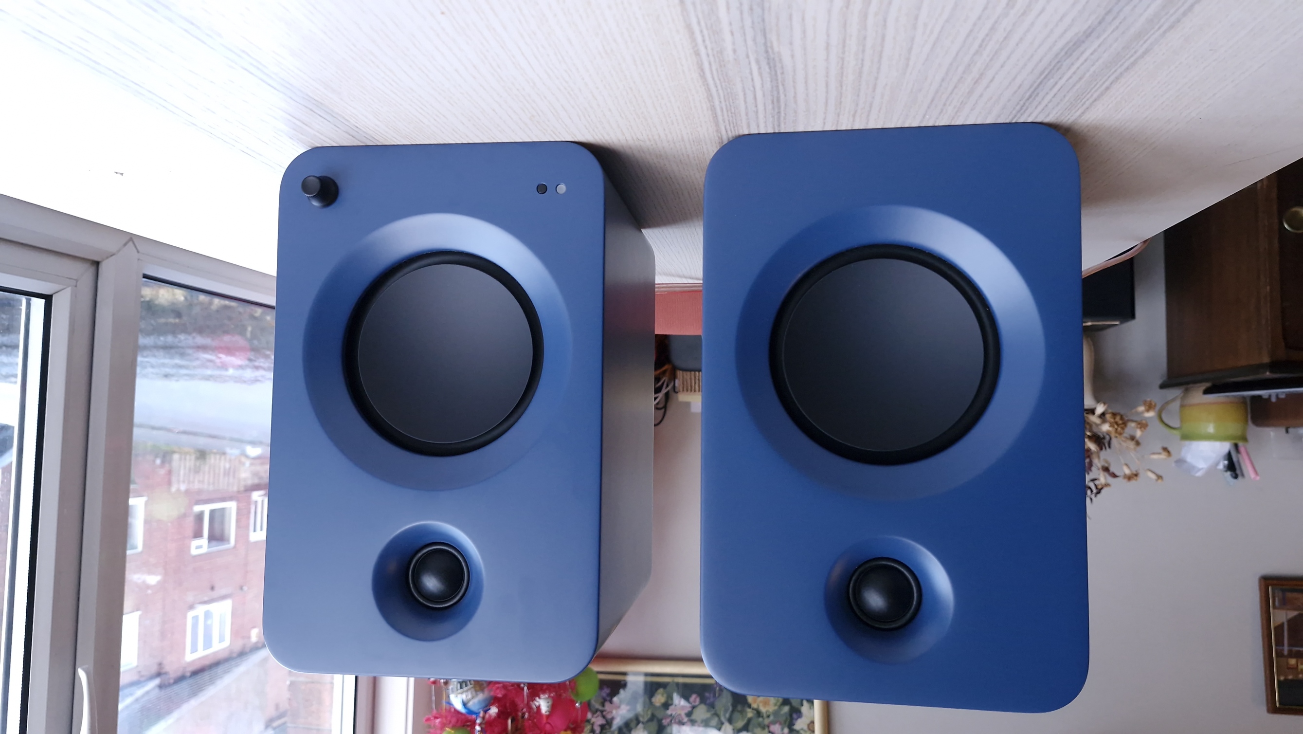 Kanto Ren speakers in blue, within a hi-fi listening room