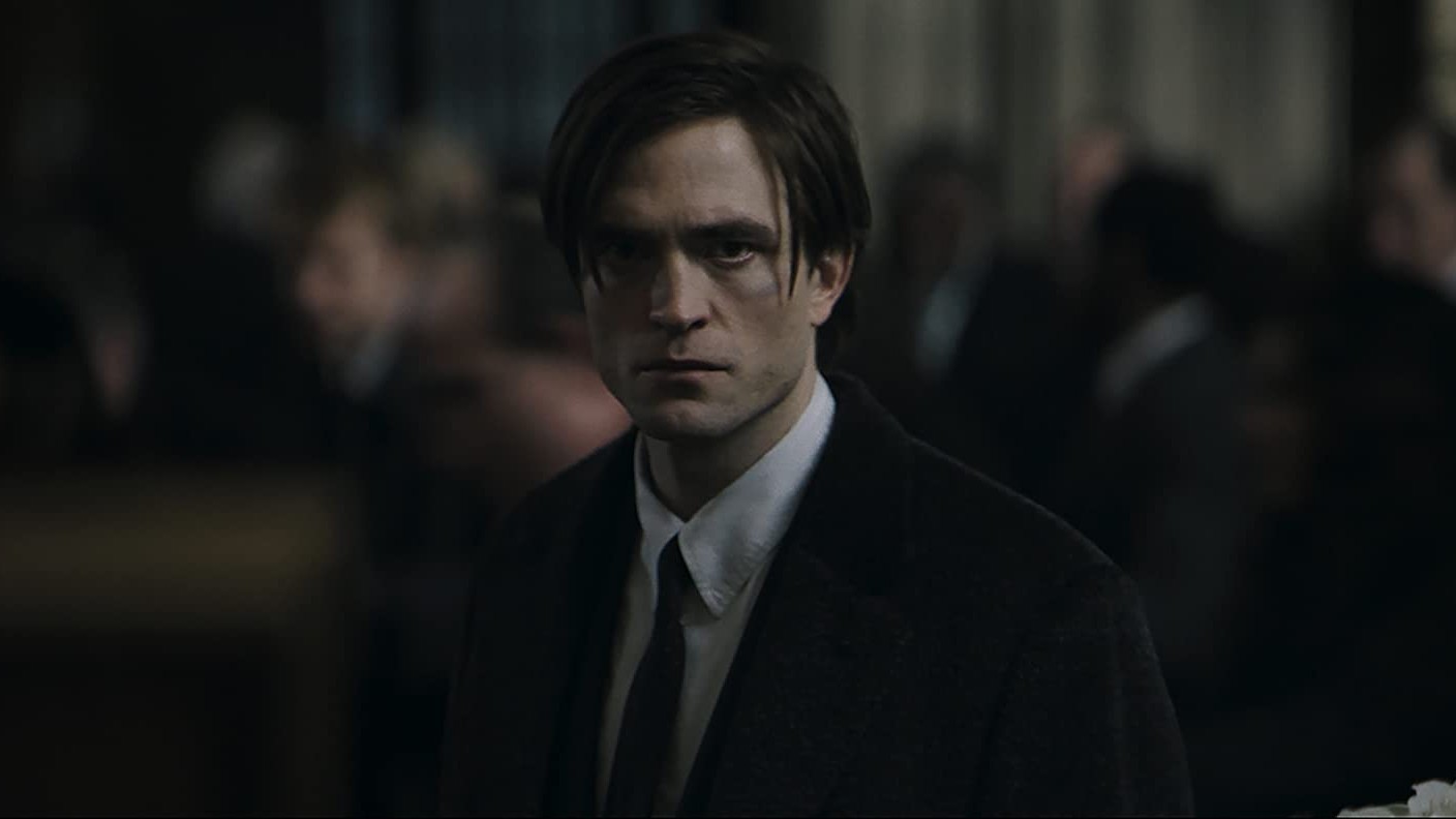 Robert Pattinson looking solemn as Bruce Wayne in The Batman movie