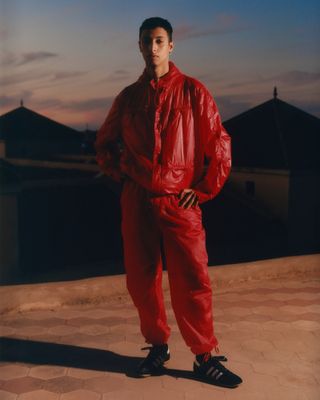 Man wearing red outfit in Moroccan twilight