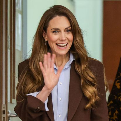 Princess Kate wearing a brown blazer and waving