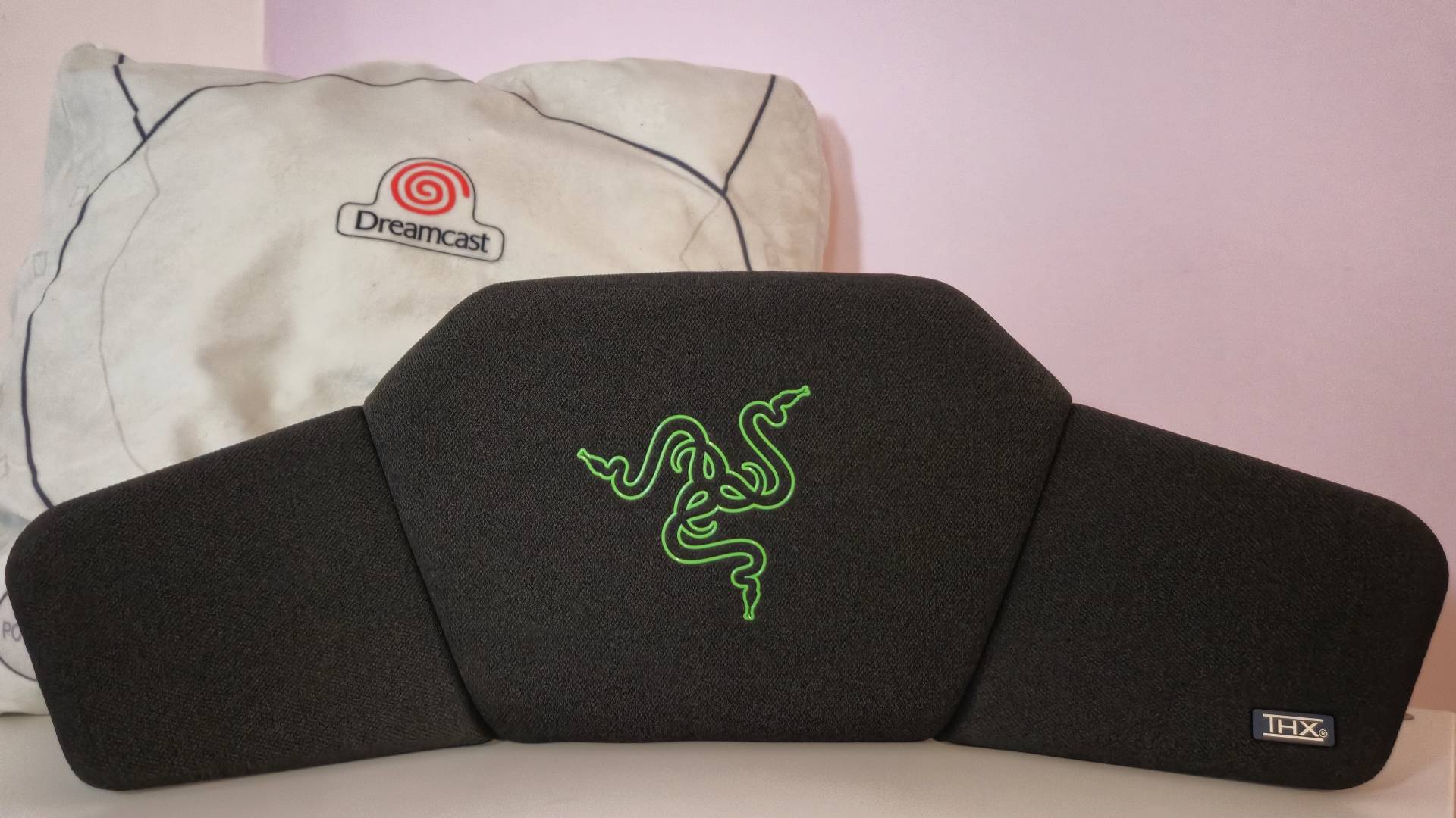 Photo by Rosalie Newcombe of the Razer Clio sitting in front of a SEGA Dreamcast cushion.