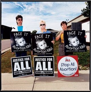 three women with anti-abortion signs