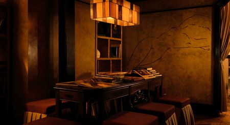 An atmospheric bar reception with a vintage wood desk, red leather and fabric stools, a pendant lamp in tempered squares of golden glass, and a mural depicting a woman stretching on her back nude.