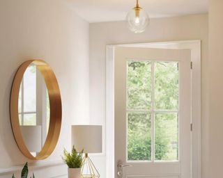 White entryway with gold light fixture