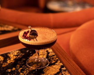 Dark frothy cocktail on bar table at Monterrey Bar